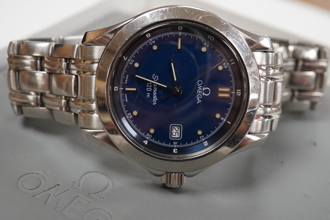 A gentleman's 1990's stainless steel Omega Seamaster quartz wrist watch, with blue dial dot markers and date aperture, case diameter 36mm, on a stainless steel Omega bracelet, with box and papers.